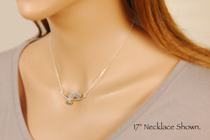 love birds necklace on a model 